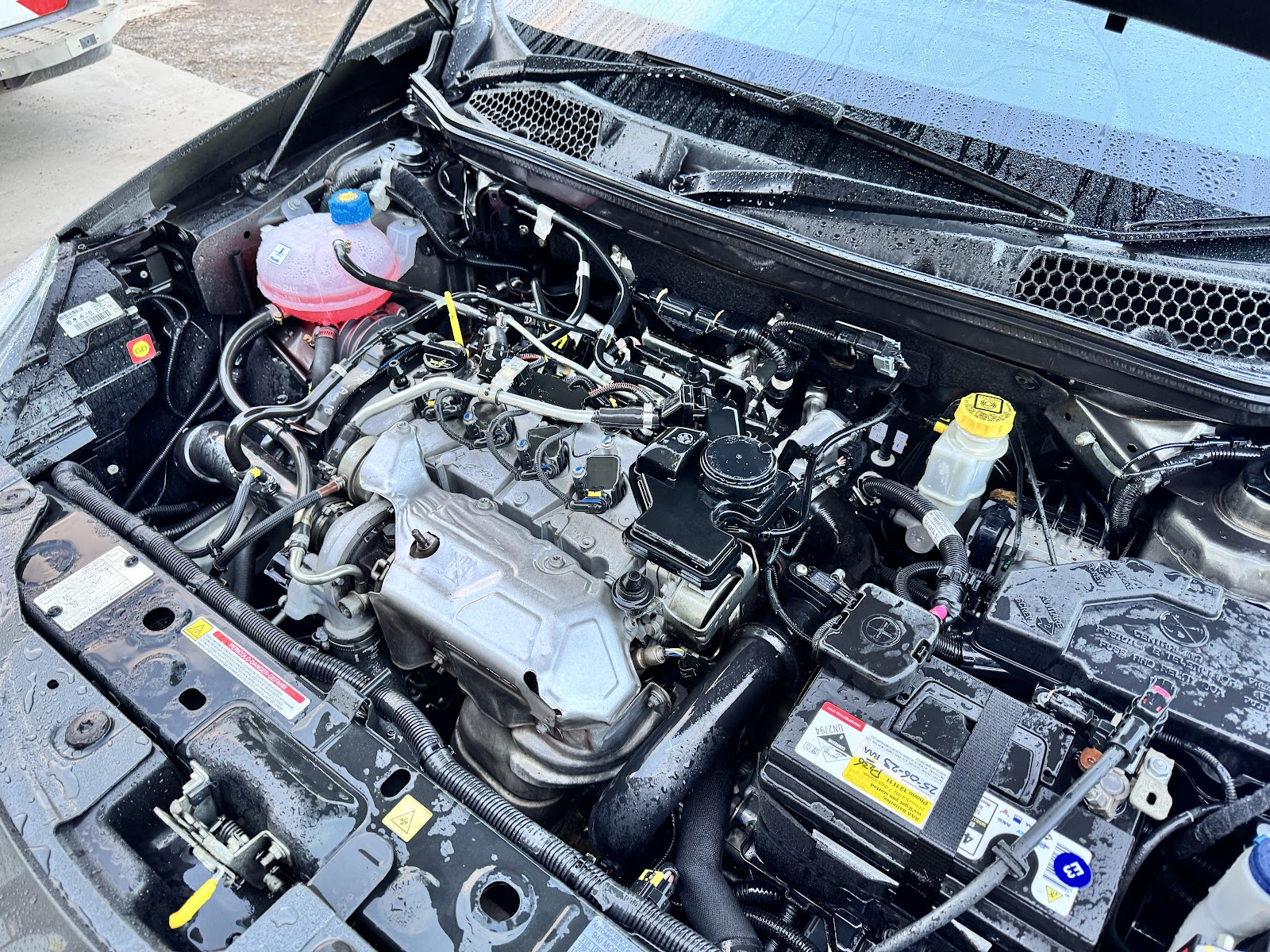 An engine bay in the workshop with a new RAA battery fitted
